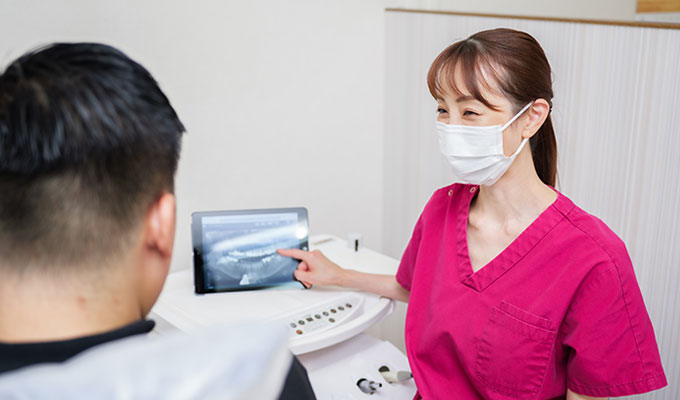 患者に説明している院長